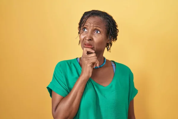 Mulher Africana Com Dreadlocks Sobre Fundo Amarelo Pensando Preocupado Com — Fotografia de Stock