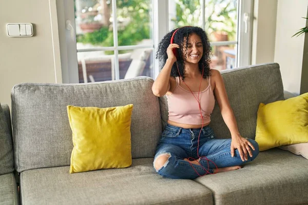 Young Hispanic Woman Listening Music Sitting Sofa Home — Stockfoto