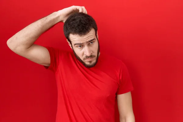 Young Hispanic Man Wearing Casual Red Shirt Confuse Wondering Question — Fotografia de Stock