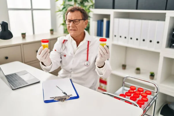Middle Age Man Wearing Doctor Uniform Holding Urine Test Tubes — Stock Photo, Image
