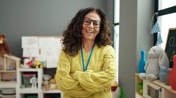 Middle Age Hispanic Woman Preschool Teacher Smiling Confident Standing Arms — ストック写真