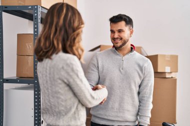 Man and woman ecommerce business workers shake hands at office
