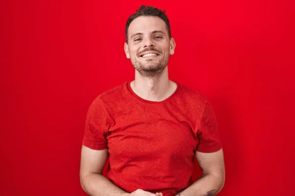 Young Hispanic Man Standing Red Background Hands Together Crossed Fingers — Stockfoto