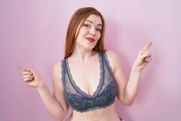 Redhead Woman Wearing Lingerie Pink Background Smiling Confident Pointing Fingers — Stock Photo, Image