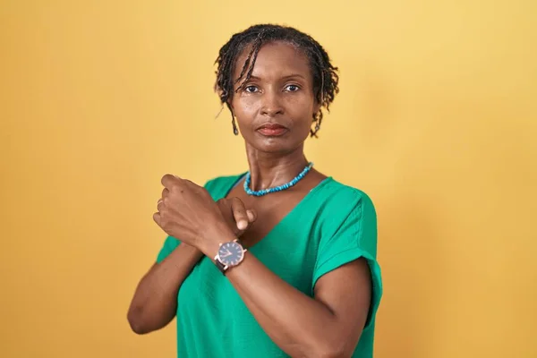 Африканская Женщина Дредами Стоит Желтом Фоне Спешке Указывая Часы Нетерпение — стоковое фото