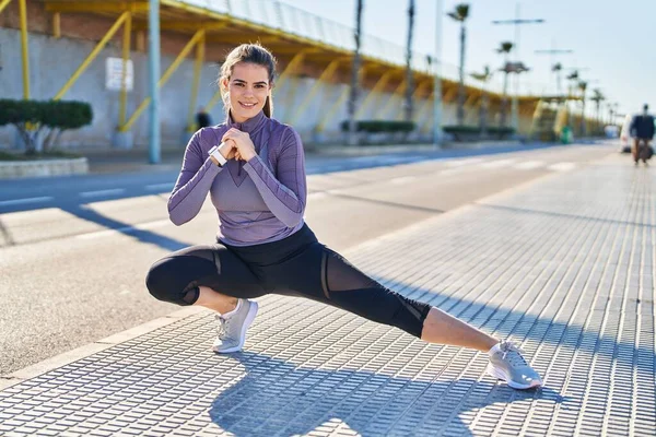 Young Beautiful Hispanic Woman Wearing Sportswear Stretching Leg Street — Stockfoto
