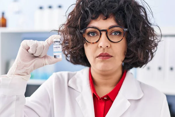 Hispanic Doctor Woman Curly Hair Holding Vaccine Thinking Attitude Sober — Stock Photo, Image