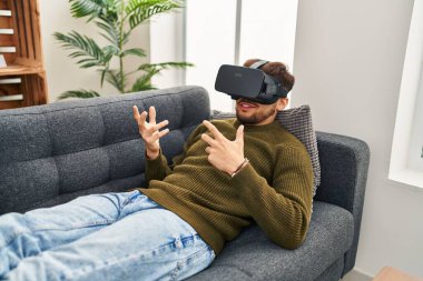 Young arab man patient having mental session using vr glasses at psychology center