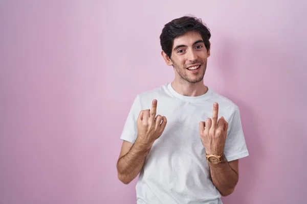 Young Hispanic Man Standing Pink Background Showing Middle Finger Doing — Stockfoto