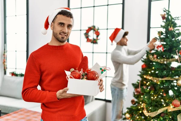 Two Hispanic Men Couple Smiling Confident Decorating Christmas Tree Home — ストック写真