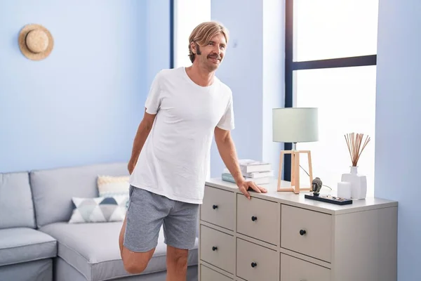 Young Blond Man Smiling Confident Stretching Leg Home — Stock Photo, Image