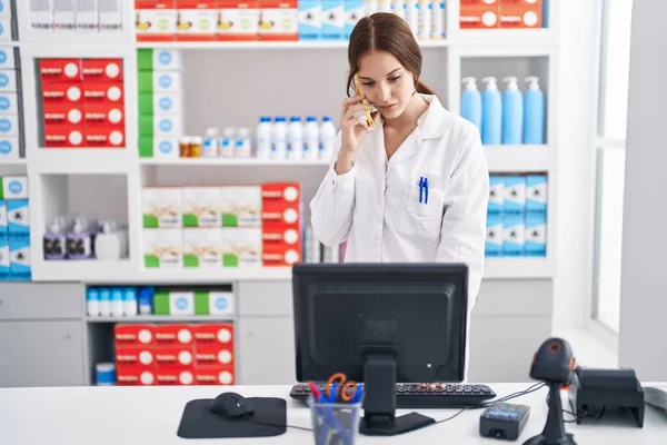 Young Woman Pharmacist Talking Smartphone Working Pharmacy — Stok fotoğraf