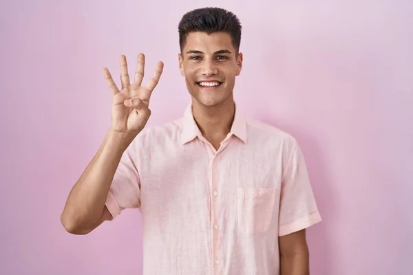 Young Hispanic Man Standing Pink Background Showing Pointing Fingers Number — ストック写真