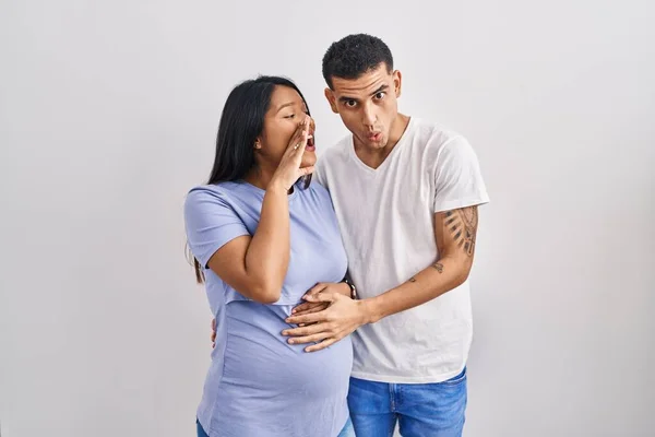 Young Hispanic Couple Expecting Baby Standing Background Hand Mouth Telling — Stock Photo, Image