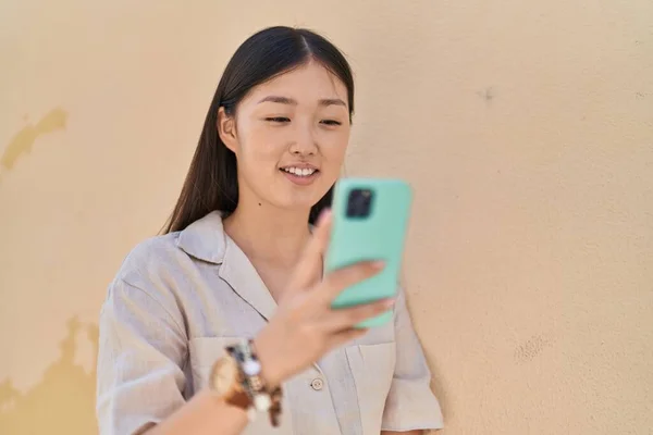 Chinese Woman Smiling Confident Using Smartphone White Isolated Background — Stock Photo, Image
