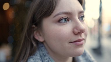 Young blonde woman smiling confident looking to the side at street