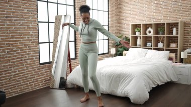 African american woman smiling confident dancing at bedroom