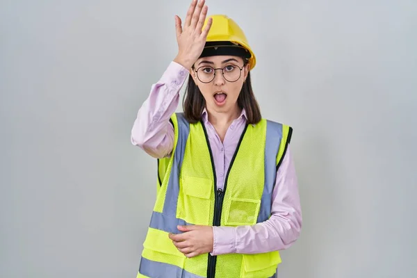 Menina Hispânica Vestindo Uniforme Construtor Hardhat Surpreendido Com Mão Cabeça — Fotografia de Stock