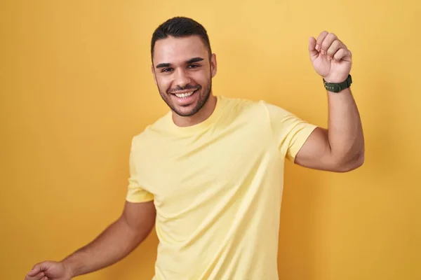 Young Hispanic Man Standing Yellow Background Dancing Happy Cheerful Smiling — 스톡 사진