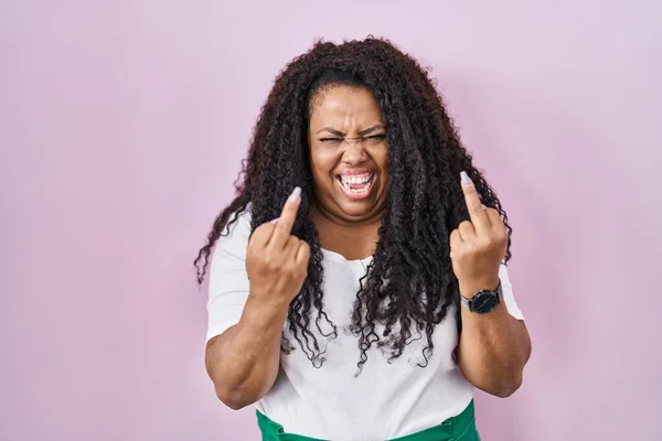 Size Hispanic Woman Standing Pink Background Showing Middle Finger Doing — стоковое фото