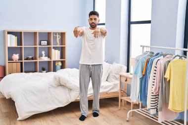 Young hispanic man sleepwalking at bedroom