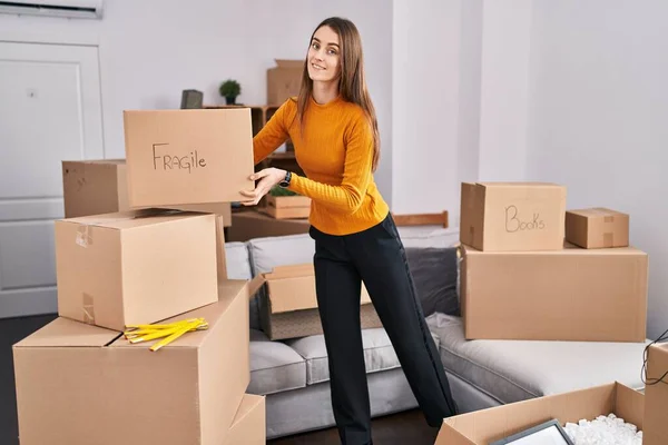 Young Caucasian Woman Smiling Confident Holding Fragile Package New Home — Fotografia de Stock