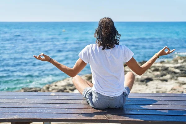 Young Hispanic Man Doing Yoga Exercise Sitting Bench Seaside — Stock Fotó