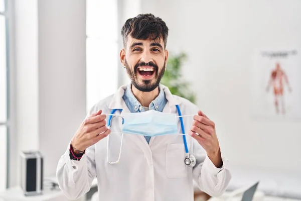 Young Hispanic Doctor Man Beard Holding Safety Mask Smiling Laughing — Stock Photo, Image