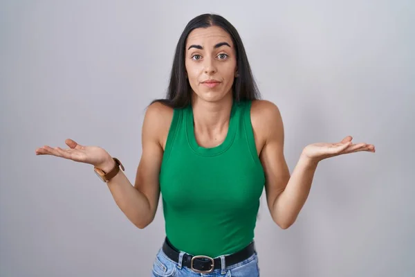 Young Woman Standing Isolated Background Clueless Confused Expression Arms Hands — Stock Photo, Image