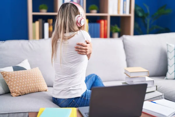 Young Blonde Woman Studying Using Computer Laptop Home Hugging Oneself — Stock Photo, Image