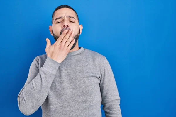 Hispanic Man Standing Blue Background Bored Yawning Tired Covering Mouth — Stock Photo, Image