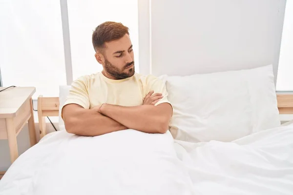 Young Hispanic Man Sitting Bed Unhappy Expression Arms Crossed Gesture — Stockfoto