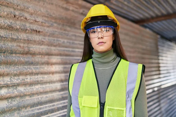 stock image Young beautiful hispanic woman architect standing with serious expression at street