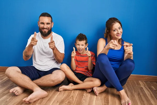 Family Three Sitting Floor Home Pointing Fingers Camera Happy Funny — Stock Photo, Image