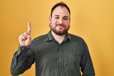 Ayrıca sarı arka planda duran sakallı İspanyol adam bir numaralı parmağını gösterip gülümserken kendinden emin ve mutlu.. 