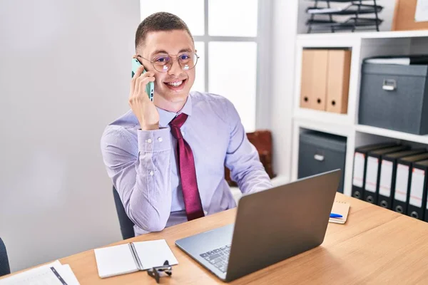 Young Hispanic Man Business Worker Using Laptop Talking Smartphone Office — Fotografia de Stock