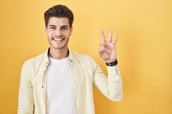 Young Hispanic Man Standing Yellow Background Showing Pointing Fingers Number — Stok fotoğraf