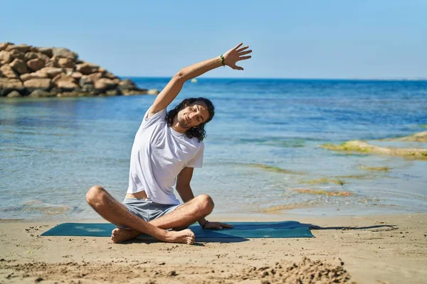 Young Hispanic Man Doing Yoga Exercise Sitting Sand Beach — Fotografia de Stock