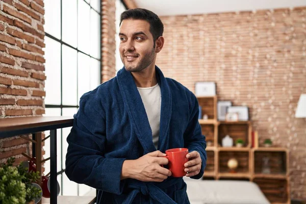 Young Hispanic Man Wearing Robe Drinking Coffee Home — Stok fotoğraf