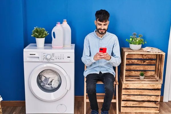 Νεαρός Ισπανός Που Χρησιμοποιεί Smartphone Περιμένοντας Πλυντήριο Στο Πλυσταριό — Φωτογραφία Αρχείου