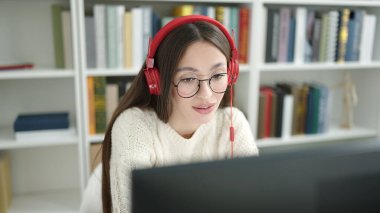 Young beautiful hispanic woman student smiling confident having video call at library university