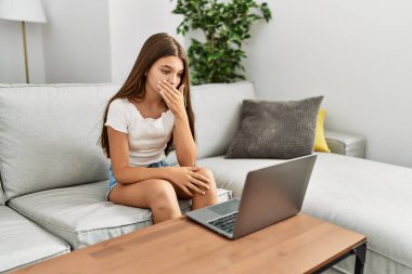 Evdeki kanepede oturup sağır dille iletişim kuran sevimli bir kız.