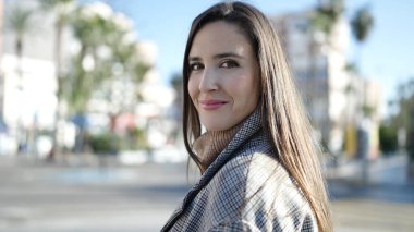 Güzel İspanyol kadın sokakta kendine güvenerek gülümsüyor