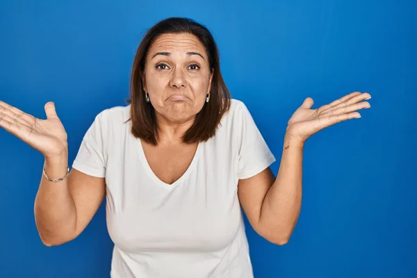 Hispanic Mature Woman Standing Blue Background Clueless Confused Expression Arms — Stock Photo, Image