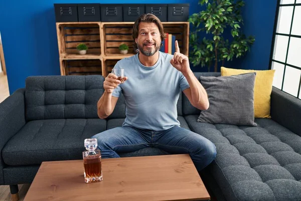 Handsome Middle Age Man Drinking Glass Whiskey Sitting Sofa Surprised — Stock Photo, Image