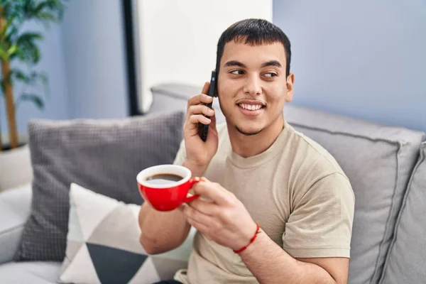 Young Man Drinking Coffee Talking Smartphone Home — Foto de Stock
