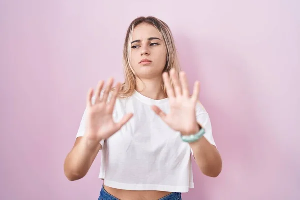 Young Blonde Woman Standing Pink Background Moving Away Hands Palms — Stockfoto