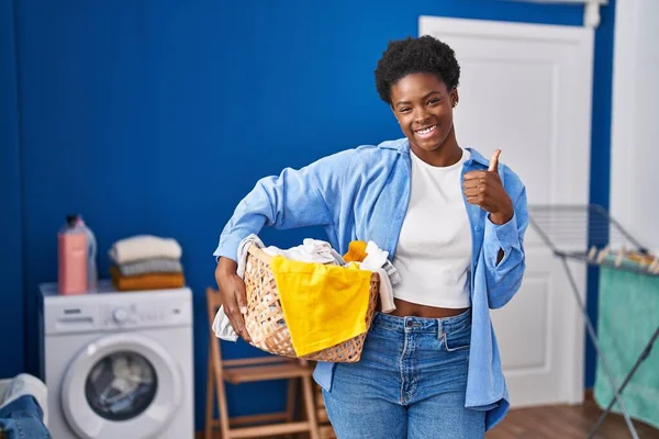 African American Woman Holding Laundry Basket Smiling Happy Positive Thumb — Fotografia de Stock