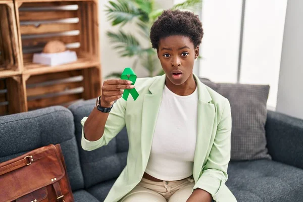 African American Woman Holding Support Green Ribbon Scared Amazed Open — Stock Photo, Image
