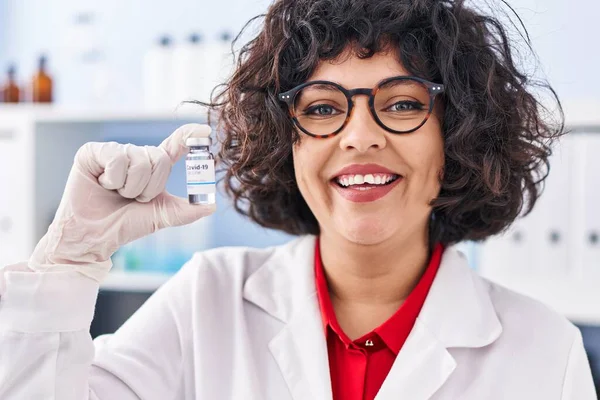 Hispanic Doctor Woman Curly Hair Holding Vaccine Looking Positive Happy — Stock Photo, Image